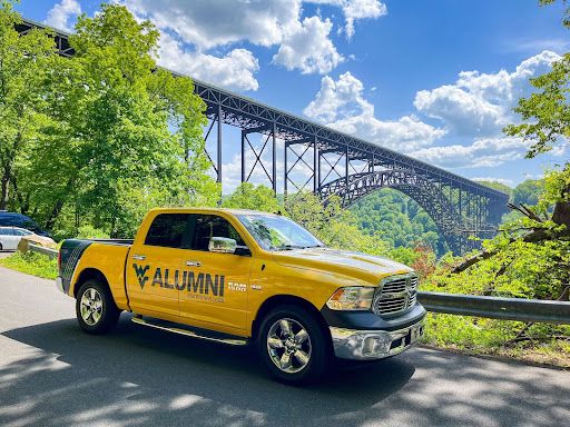 the WVU Alumni Truck in front of the New River Gorge Bridge